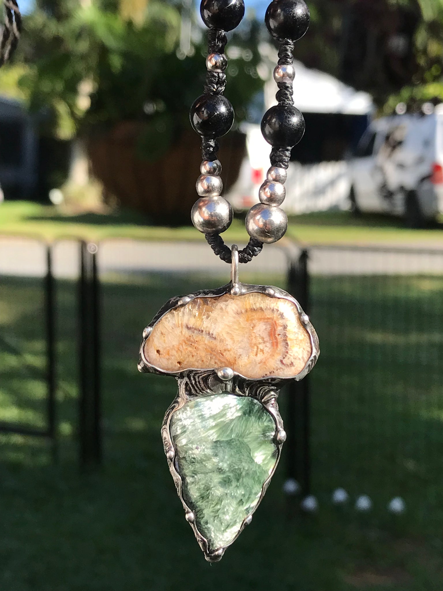 Seraphinite and fossilised coral pendant