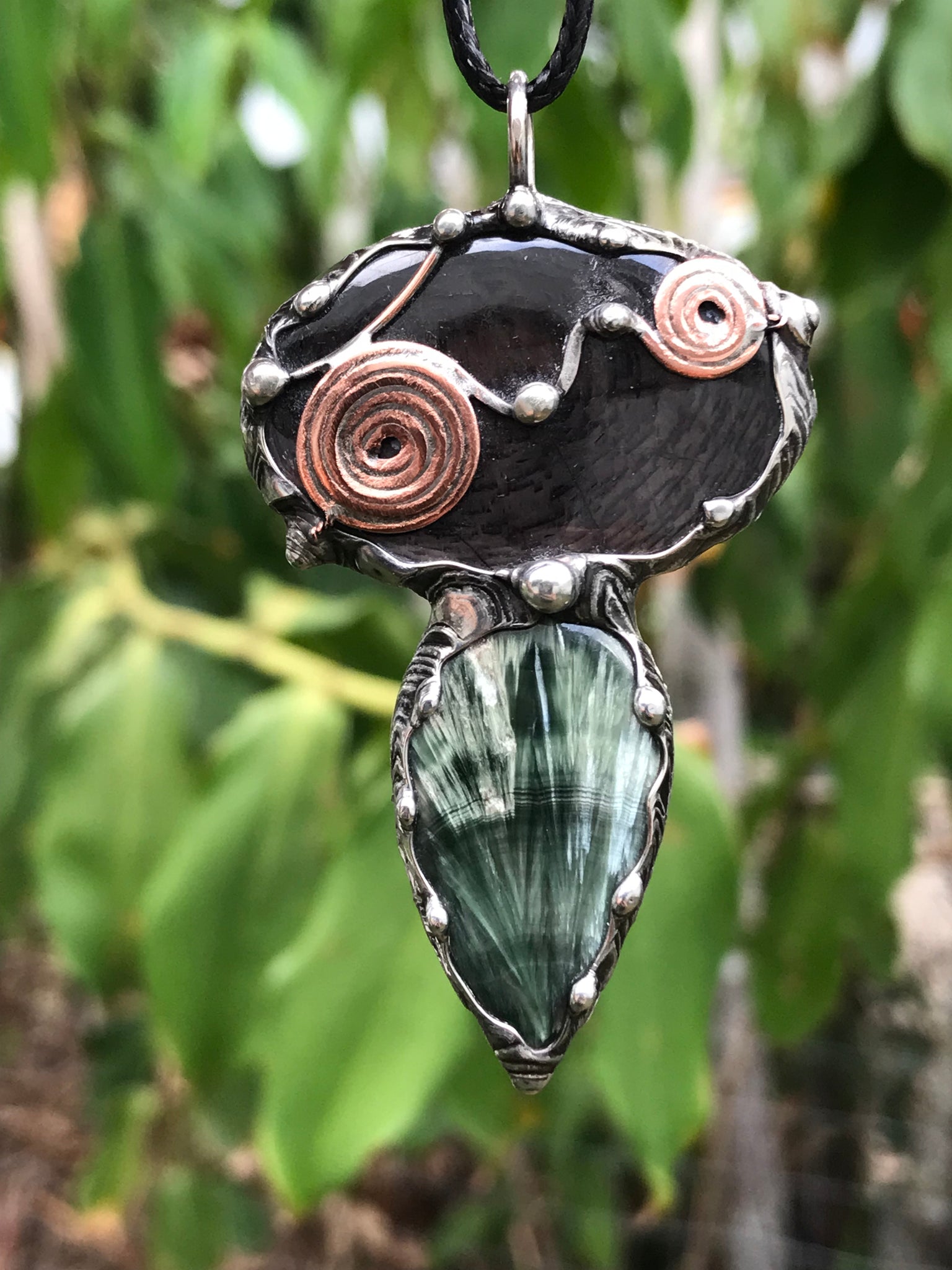Double spiralled Hypersthene and Seraphinite pendant