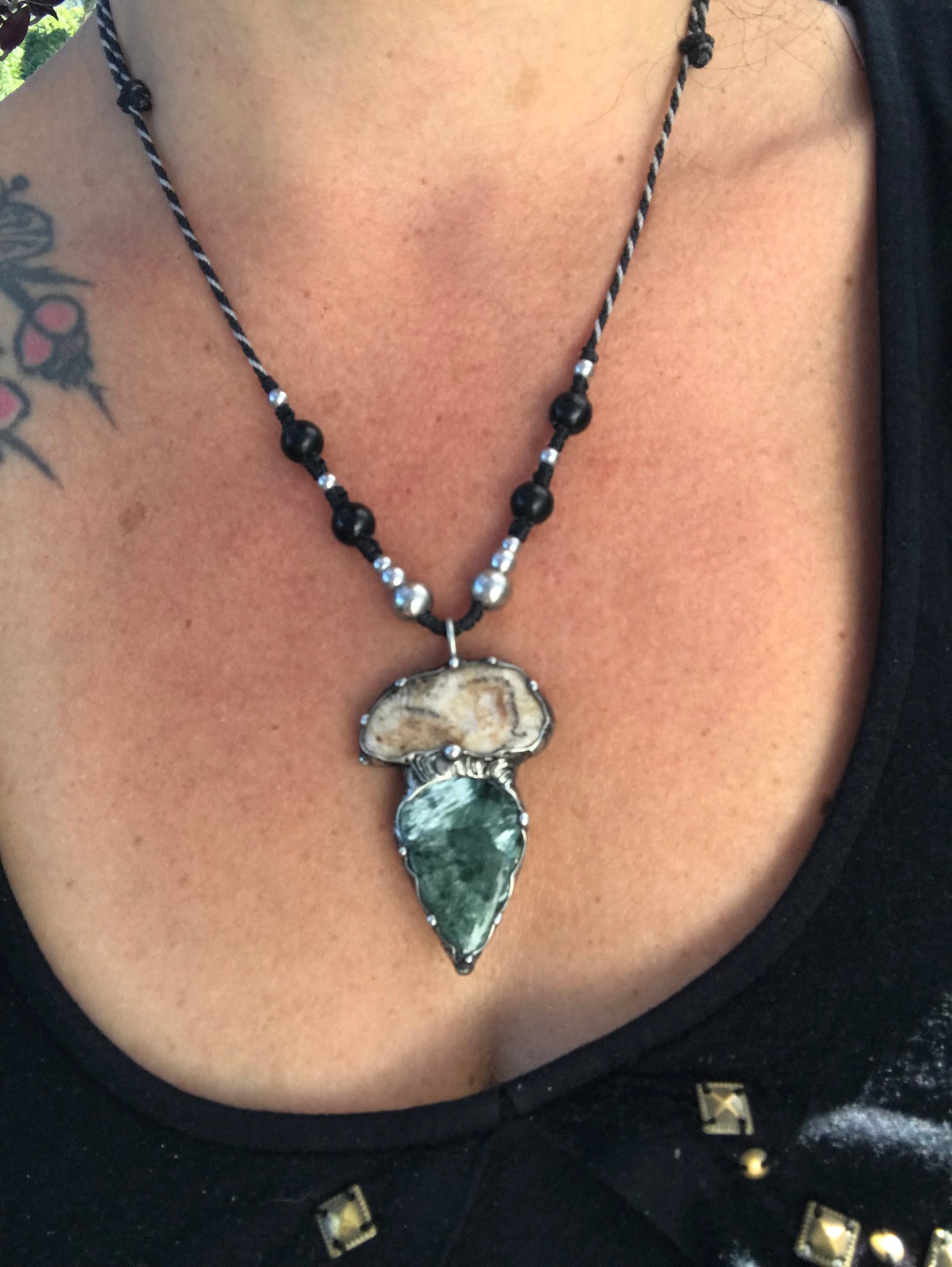 Seraphinite and fossilised coral pendant