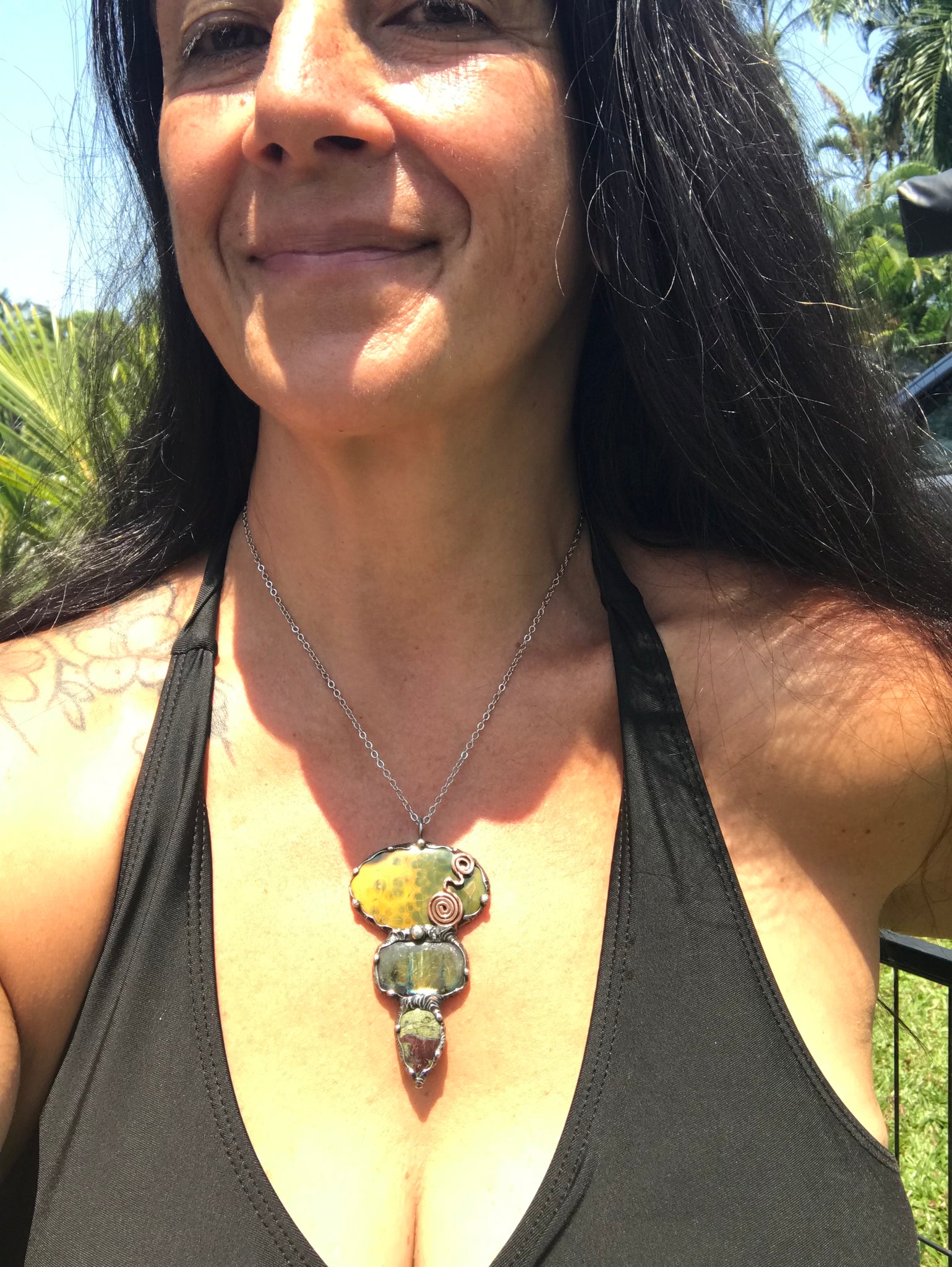 Ocean jasper Labradorite and Dragon Blood Jasper crystal pendant adorned eith a double spiral symbol