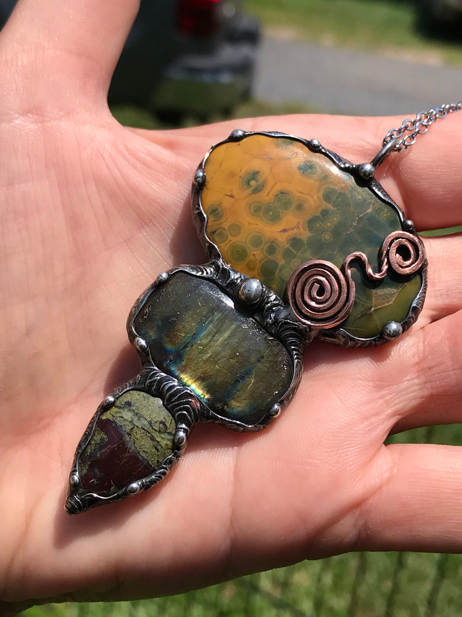 Ocean jasper Labradorite and Dragon Blood Jasper crystal pendant adorned eith a double spiral symbol