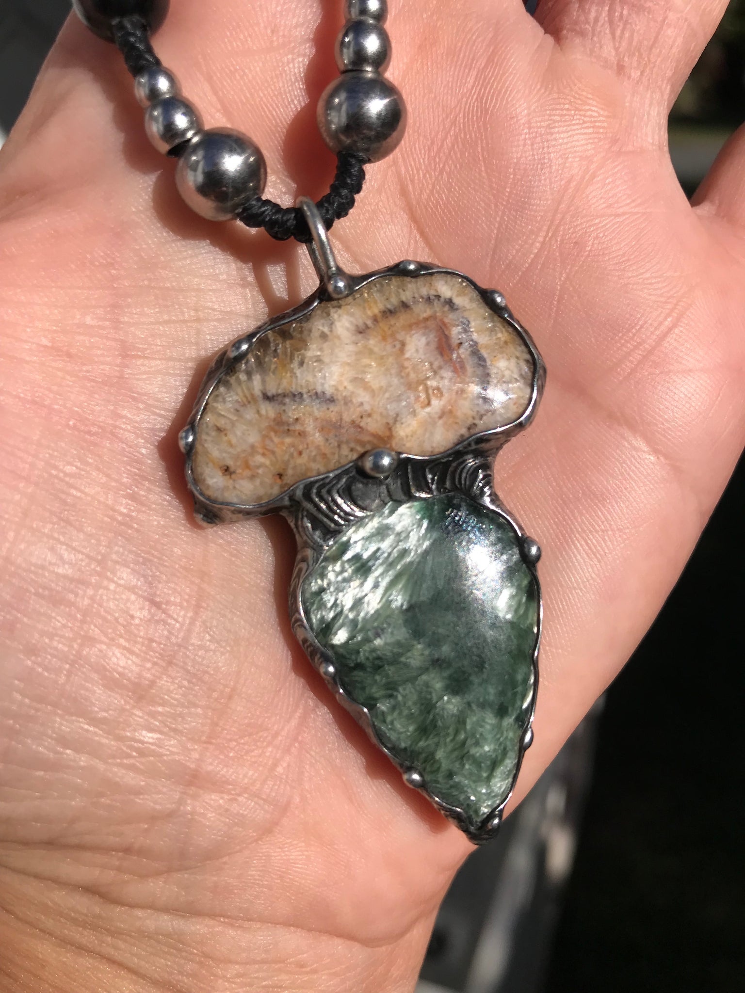 Seraphinite and fossilised coral pendant